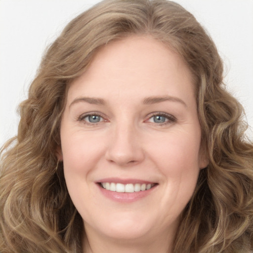 Joyful white young-adult female with long  brown hair and green eyes