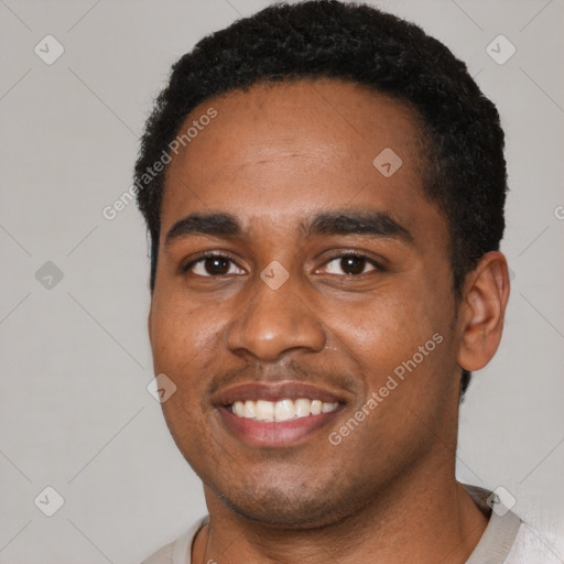 Joyful black young-adult male with short  black hair and brown eyes