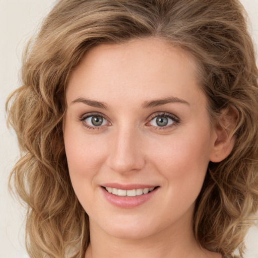 Joyful white young-adult female with long  brown hair and green eyes