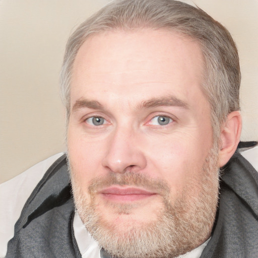 Joyful white adult male with short  brown hair and blue eyes