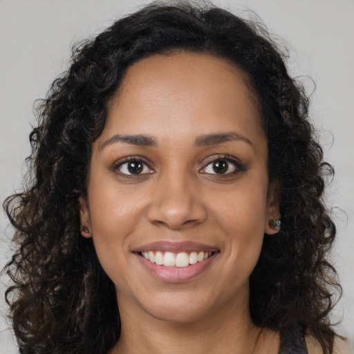 Joyful latino young-adult female with long  brown hair and brown eyes