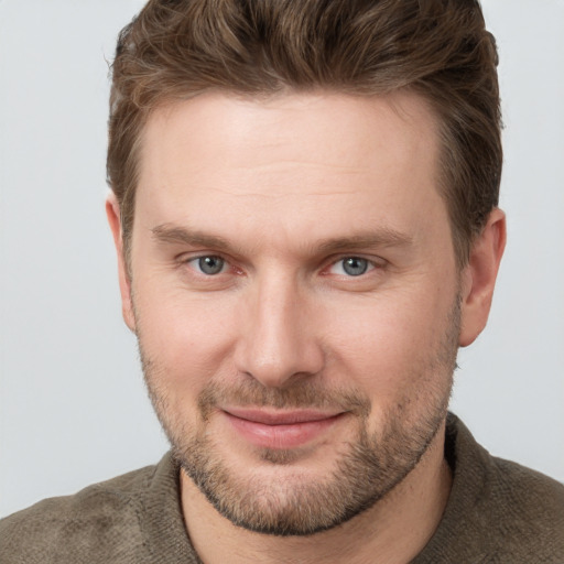 Joyful white adult male with short  brown hair and grey eyes