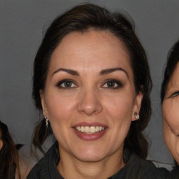 Joyful white adult female with long  brown hair and brown eyes