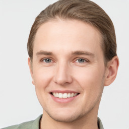 Joyful white young-adult male with short  brown hair and grey eyes