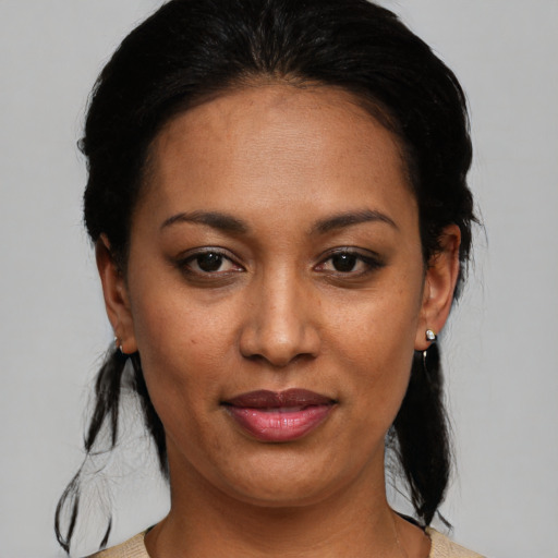Joyful black young-adult female with medium  black hair and brown eyes