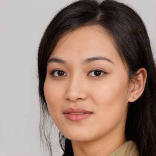 Joyful asian young-adult female with long  brown hair and brown eyes