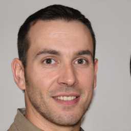 Joyful white young-adult male with short  brown hair and brown eyes