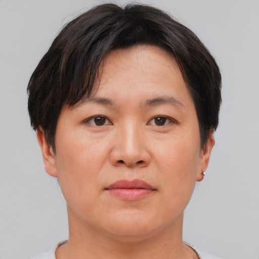 Neutral asian adult female with short  brown hair and brown eyes