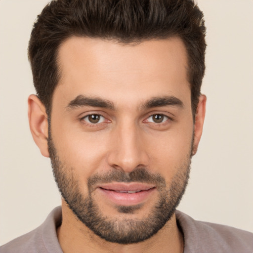 Joyful white young-adult male with short  brown hair and brown eyes