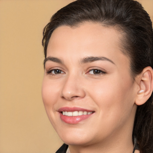 Joyful white young-adult female with long  brown hair and brown eyes