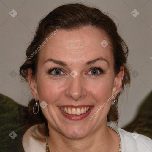 Joyful white adult female with medium  brown hair and blue eyes