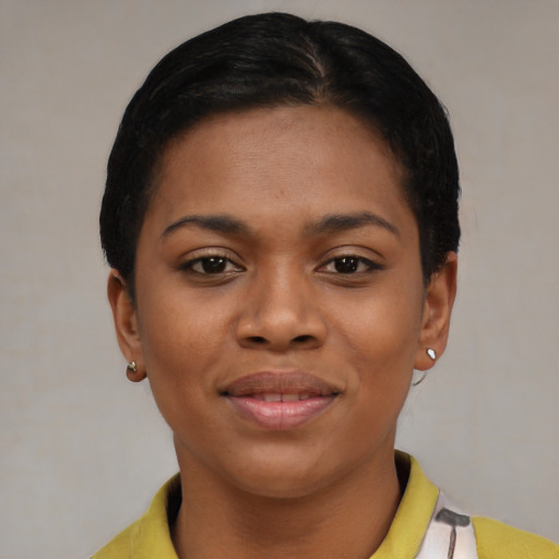Joyful latino young-adult female with short  black hair and brown eyes