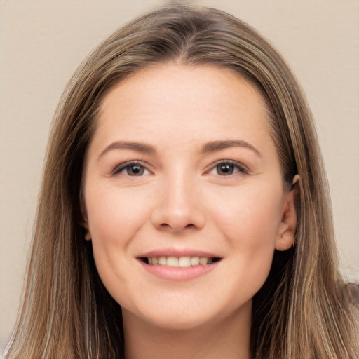 Joyful white young-adult female with long  brown hair and grey eyes