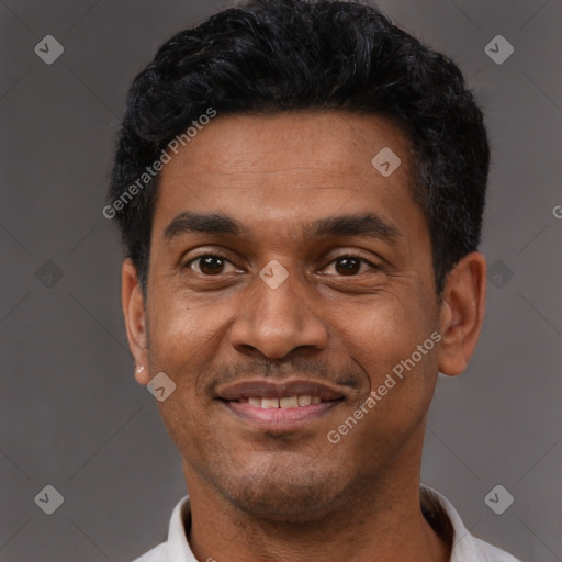 Joyful latino adult male with short  black hair and brown eyes