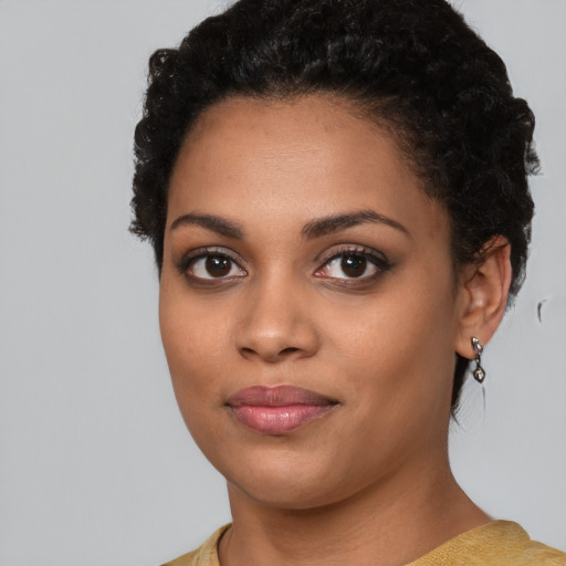 Joyful latino young-adult female with short  black hair and brown eyes
