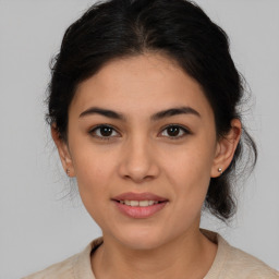 Joyful latino young-adult female with medium  brown hair and brown eyes