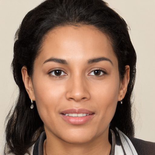 Joyful latino young-adult female with long  brown hair and brown eyes