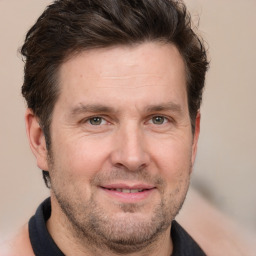 Joyful white adult male with short  brown hair and grey eyes