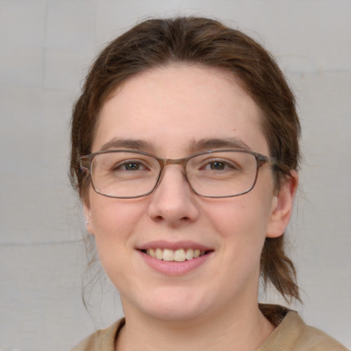 Joyful white adult female with medium  brown hair and blue eyes