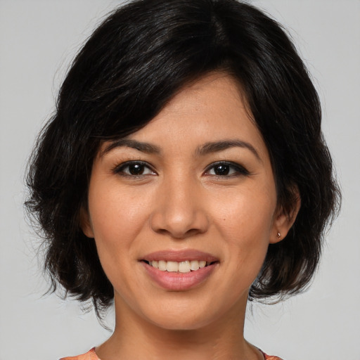 Joyful asian young-adult female with medium  black hair and brown eyes