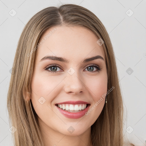 Joyful white young-adult female with long  brown hair and green eyes