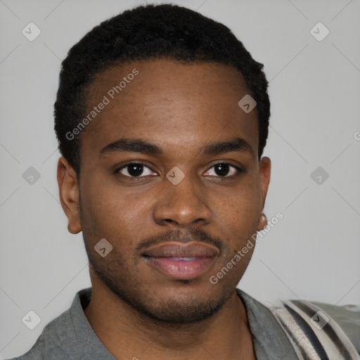 Joyful black young-adult male with short  brown hair and brown eyes