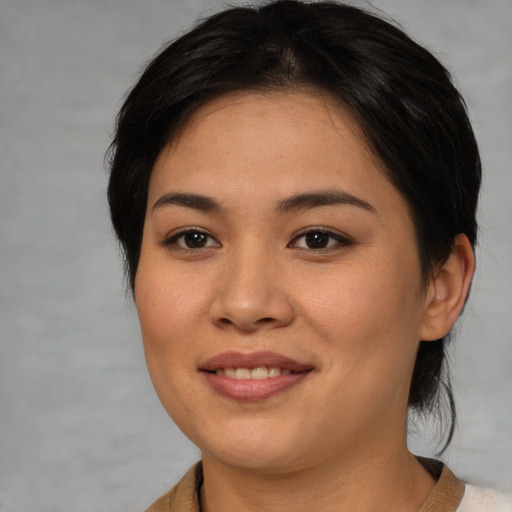 Joyful asian young-adult female with medium  brown hair and brown eyes