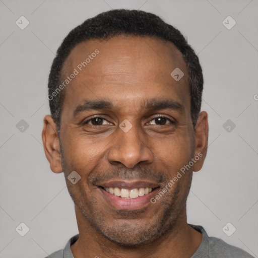 Joyful latino adult male with short  black hair and brown eyes