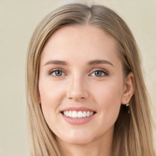 Joyful white young-adult female with long  brown hair and green eyes