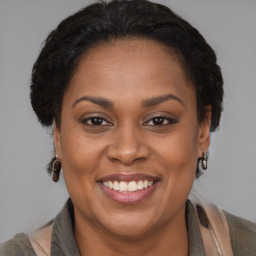 Joyful latino adult female with medium  brown hair and brown eyes