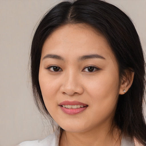 Joyful asian young-adult female with long  black hair and brown eyes
