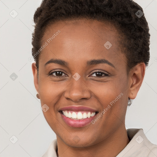 Joyful black young-adult female with short  brown hair and brown eyes