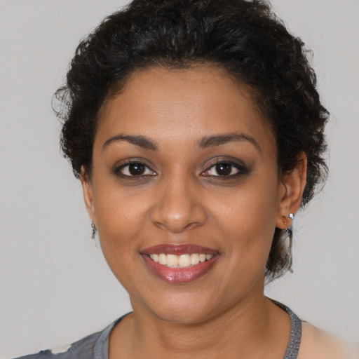 Joyful latino young-adult female with short  brown hair and brown eyes
