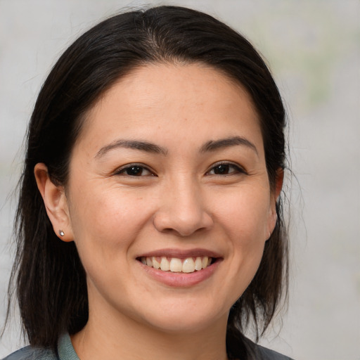 Joyful white young-adult female with medium  brown hair and brown eyes