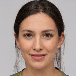 Joyful white young-adult female with medium  brown hair and brown eyes