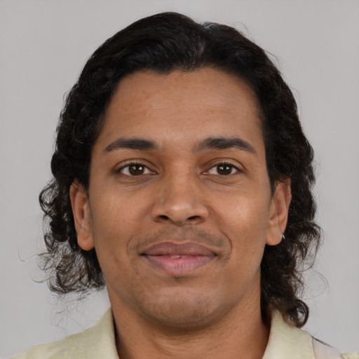 Joyful black adult male with short  brown hair and brown eyes
