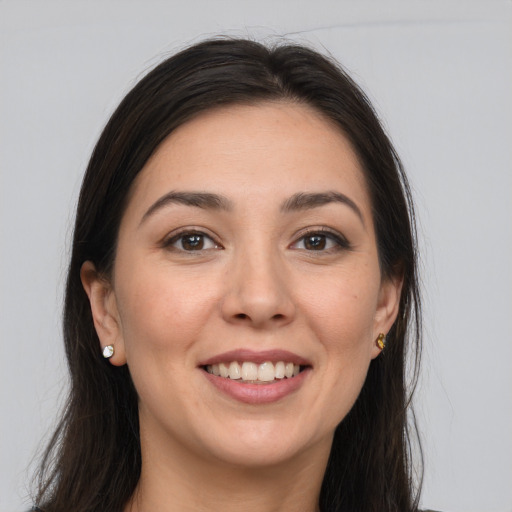 Joyful white young-adult female with long  brown hair and brown eyes