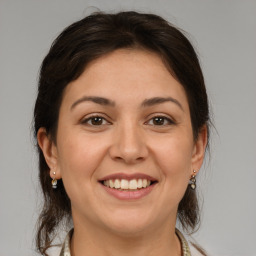 Joyful white young-adult female with medium  brown hair and brown eyes