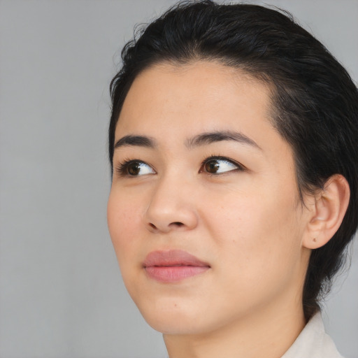 Joyful white young-adult female with medium  black hair and brown eyes