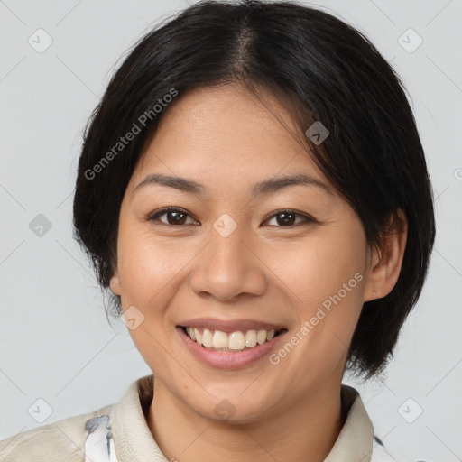 Joyful asian young-adult female with medium  brown hair and brown eyes