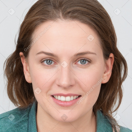 Joyful white young-adult female with medium  brown hair and blue eyes