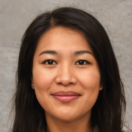 Joyful asian young-adult female with long  brown hair and brown eyes