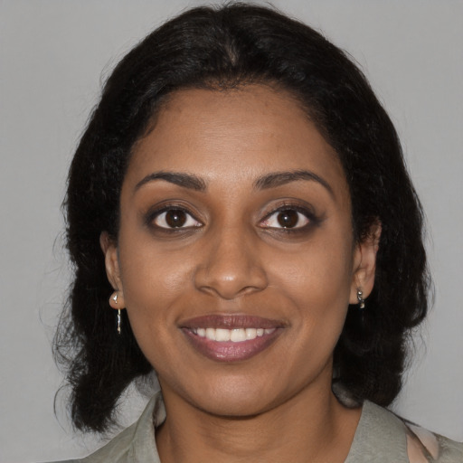 Joyful black young-adult female with medium  black hair and brown eyes