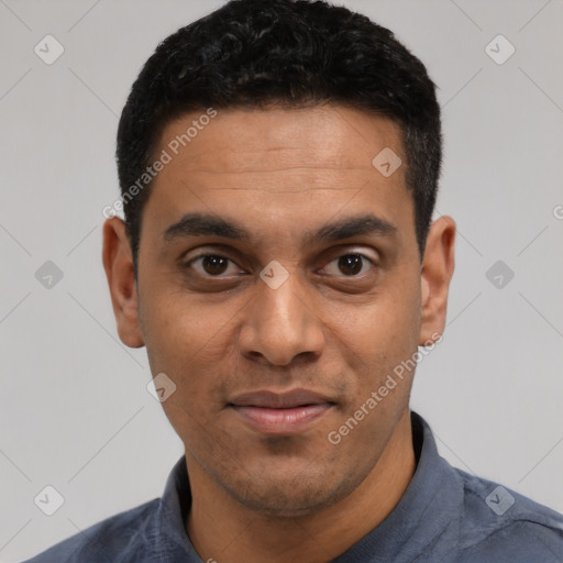 Joyful latino young-adult male with short  black hair and brown eyes