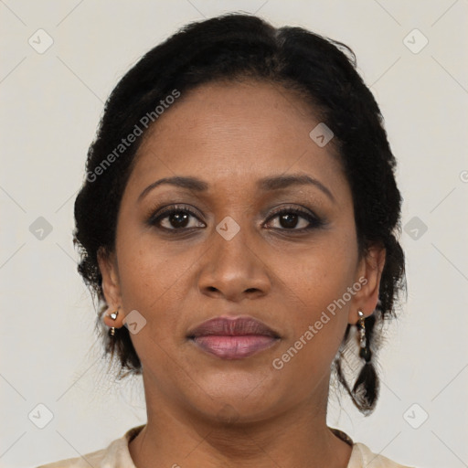 Joyful black adult female with medium  brown hair and brown eyes