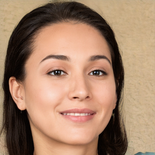 Joyful white young-adult female with long  brown hair and brown eyes