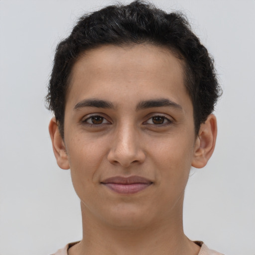 Joyful latino young-adult female with short  brown hair and brown eyes