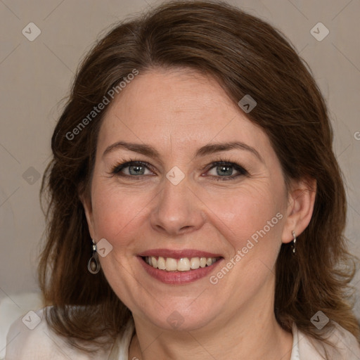 Joyful white adult female with medium  brown hair and grey eyes