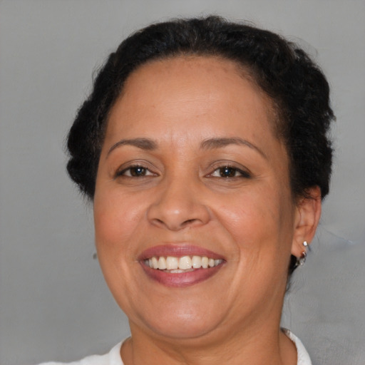 Joyful black adult female with short  brown hair and brown eyes