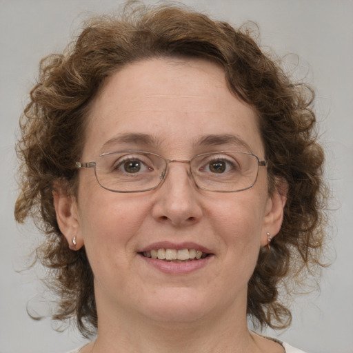 Joyful white adult female with medium  brown hair and blue eyes